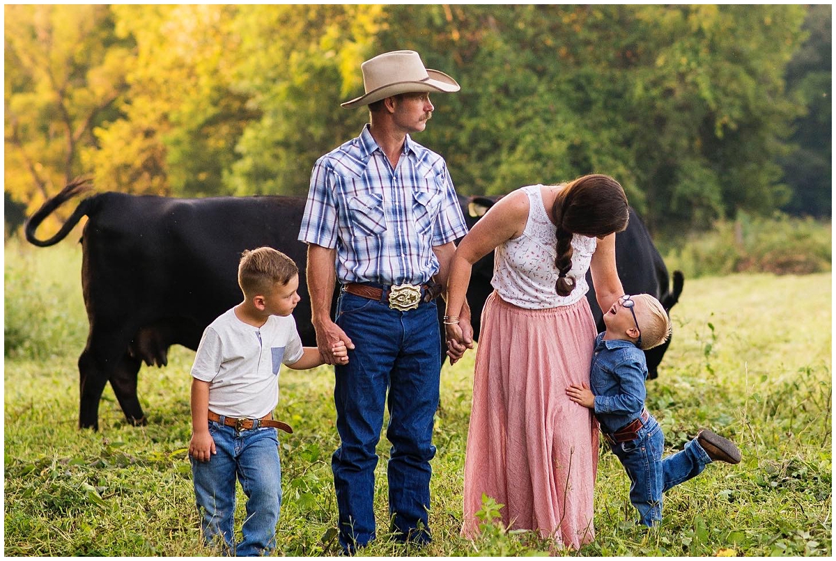 Christina Swanson and Family playing in the cattle field during family photos