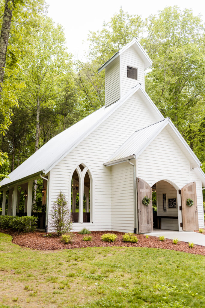 Exterior view of the all-white Chapel at Firefly Lane, a wedding venue located outside Nashville, Tennessee